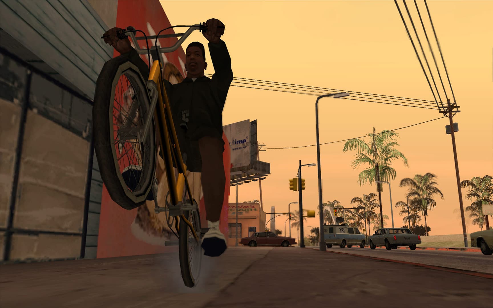 CJ hace un caballito en bicicleta en una calle de Los Santos al atardecer en GTA San Andreas